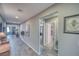 Bright hallway with wood-look tile flooring and doorways to adjacent rooms at 5360 S Chippewa St, Pahrump, NV 89061