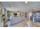Open-concept living room with a large sectional sofa, TV, ceiling fan, and seamless flow into the kitchen at 5360 S Chippewa St, Pahrump, NV 89061
