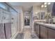 Spacious main bathroom with dual sinks, a walk-in shower, and access to a walk-in closet at 5360 S Chippewa St, Pahrump, NV 89061