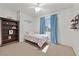 Bright bedroom with cozy carpet, window, and ceiling fan at 6116 Golden Saddle St, Las Vegas, NV 89130