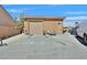 Exterior view of the detached garage with a large door and parking area for multiple vehicles at 6116 Golden Saddle St, Las Vegas, NV 89130