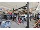 The garage has an auto lift and storage, a large area for working on vehicles or hobbies at 6116 Golden Saddle St, Las Vegas, NV 89130