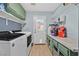 Functional laundry room with washer, dryer, storage and door to outside at 6116 Golden Saddle St, Las Vegas, NV 89130