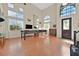 Bright living room with high ceilings, large windows, and beautiful wood floors at 6116 Golden Saddle St, Las Vegas, NV 89130