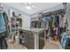 Large walk-in closet with custom storage solutions and center island for accessories at 6116 Golden Saddle St, Las Vegas, NV 89130