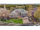 Aerial view of home featuring mature landscaping, a three car garage and a well manicured lawn at 6907 May Basket Ave, Las Vegas, NV 89131