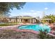 Landscaped backyard with in-ground pool, rock waterfall, fountain, jacuzzi, and covered patio at 6907 May Basket Ave, Las Vegas, NV 89131