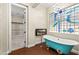 Clawfoot bathtub next to a modern blue window and a fireplace with a view to a walk-in closet at 6907 May Basket Ave, Las Vegas, NV 89131