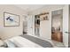 Staged bedroom with closet with views to the bathroom and dining room at 6907 May Basket Ave, Las Vegas, NV 89131