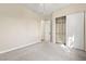 Bright bedroom featuring neutral carpet, a closet and an adjacent bathroom door at 6907 May Basket Ave, Las Vegas, NV 89131