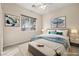 Staged bedroom with a bed, neutral colored walls and carpeting, and matching artwork on the walls at 6907 May Basket Ave, Las Vegas, NV 89131