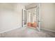 Spacious bedroom with neutral carpeting and large glass doors leading to a bright foyer at 6907 May Basket Ave, Las Vegas, NV 89131