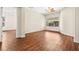 Bright, open bedroom with hardwood floors, a ceiling fan, and a large window with backyard views at 6907 May Basket Ave, Las Vegas, NV 89131