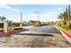Elegant gated community entrance with brick pillars, manicured landscaping, and decorative street lamps creates a welcoming ambiance at 6907 May Basket Ave, Las Vegas, NV 89131