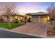 Beautiful single-story home with a well-manicured lawn, desert landscaping, and a spacious driveway leading to a two-car garage at 6907 May Basket Ave, Las Vegas, NV 89131