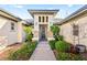 Front entrance featuring stone accents, desert landscaping, and a covered entryway at 6907 May Basket Ave, Las Vegas, NV 89131