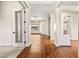 Open-concept home with hardwood floors, neutral paint, and a view into the living room and kitchen at 6907 May Basket Ave, Las Vegas, NV 89131
