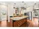 Modern kitchen features a large center island, stainless steel appliances, custom cabinets, and granite countertops at 6907 May Basket Ave, Las Vegas, NV 89131