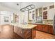 Modern kitchen island with granite countertops, stainless steel appliances and access to living area at 6907 May Basket Ave, Las Vegas, NV 89131