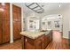 Kitchen island features stainless steel sink, barstool seating, and adjacent access to the formal dining area at 6907 May Basket Ave, Las Vegas, NV 89131