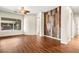 Open-concept living room boasts a wood accent wall, hardwood floors, and backyard views at 6907 May Basket Ave, Las Vegas, NV 89131