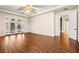 Spacious main bedroom features hardwood floors, ceiling fan, tray ceiling, and double doors to the backyard at 6907 May Basket Ave, Las Vegas, NV 89131
