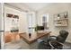 Bright office space with modern desk setup, decorative shelves, and view into formal dining area at 6907 May Basket Ave, Las Vegas, NV 89131