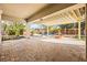 Large covered patio with brick pavers overlooking pool with rock waterfall and fountain at 6907 May Basket Ave, Las Vegas, NV 89131
