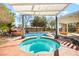 Inviting in-ground pool and jacuzzi with rock waterfall feature and well-manicured landscaping at 6907 May Basket Ave, Las Vegas, NV 89131