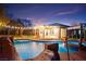 Backyard oasis features a sparkling pool with a rock waterfall, a covered patio with string lights, and a lush garden at 6907 May Basket Ave, Las Vegas, NV 89131
