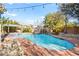 Backyard pool features a rock waterfall, jacuzzi, and lush landscaping at 6907 May Basket Ave, Las Vegas, NV 89131
