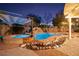 Inviting backyard pool and spa, complete with a waterfall feature and charming poolside cabana, perfect for relaxing evenings at 6907 May Basket Ave, Las Vegas, NV 89131