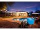 Inviting backyard pool and spa, complete with a waterfall feature and charming poolside cabana, perfect for relaxing evenings at 6907 May Basket Ave, Las Vegas, NV 89131