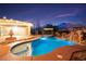 Inviting backyard pool and spa, complete with a waterfall feature and charming poolside cabana, perfect for relaxing evenings at 6907 May Basket Ave, Las Vegas, NV 89131
