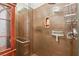 Close-up of custom shower featuring metallic textured shower walls and glass door at 6907 May Basket Ave, Las Vegas, NV 89131