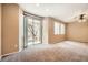 Spacious bedroom featuring large windows and a sliding glass door to the backyard at 8065 Starling View Ct, Las Vegas, NV 89166