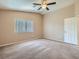Bright bedroom with large window, carpeted floor and ceiling fan at 8065 Starling View Ct, Las Vegas, NV 89166