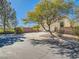 Charming home with mature tree providing shade to the two-car garage and driveway at 8065 Starling View Ct, Las Vegas, NV 89166