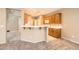 Kitchen area featuring bright white countertops, breakfast bar, and staircase view at 8065 Starling View Ct, Las Vegas, NV 89166