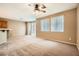 Open-concept living area with a ceiling fan, bright windows, and easy access to kitchen at 8065 Starling View Ct, Las Vegas, NV 89166