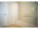 An all-white bathroom featuring a tiled shower and tub with a tiled floor at 8160 Autumn Star Ave, Las Vegas, NV 89145