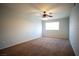 A large bedroom with plush carpeting, a ceiling fan, and neutral walls at 8160 Autumn Star Ave, Las Vegas, NV 89145