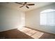 A sunny bedroom with carpeted floors and an arched window bringing in lots of light at 8160 Autumn Star Ave, Las Vegas, NV 89145