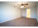 A spacious bedroom with plush carpeting, a ceiling fan, and easy bathroom access at 8160 Autumn Star Ave, Las Vegas, NV 89145