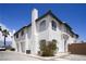 Charming two-story stucco home with attached garage, chimney, and beautiful curb appeal against a clear blue sky at 8160 Autumn Star Ave, Las Vegas, NV 89145