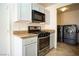 Well-lit kitchen has a gas range cooktop and newer washer and dryer at 8160 Autumn Star Ave, Las Vegas, NV 89145