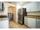 Kitchen featuring stainless steel refrigerator and a modern washer and dryer at 8160 Autumn Star Ave, Las Vegas, NV 89145