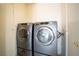 Laundry room features two modern front load washer and dryers at 8160 Autumn Star Ave, Las Vegas, NV 89145
