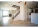 Living space with tile floors, staircase, fireplace, and open access to kitchen at 8160 Autumn Star Ave, Las Vegas, NV 89145