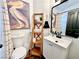 Stylish bathroom with a decorative ladder shelf, toilet, and a modern vanity at 8233 Hydra Ln, Las Vegas, NV 89128
